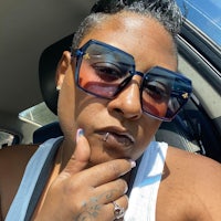 a woman wearing sunglasses in a car